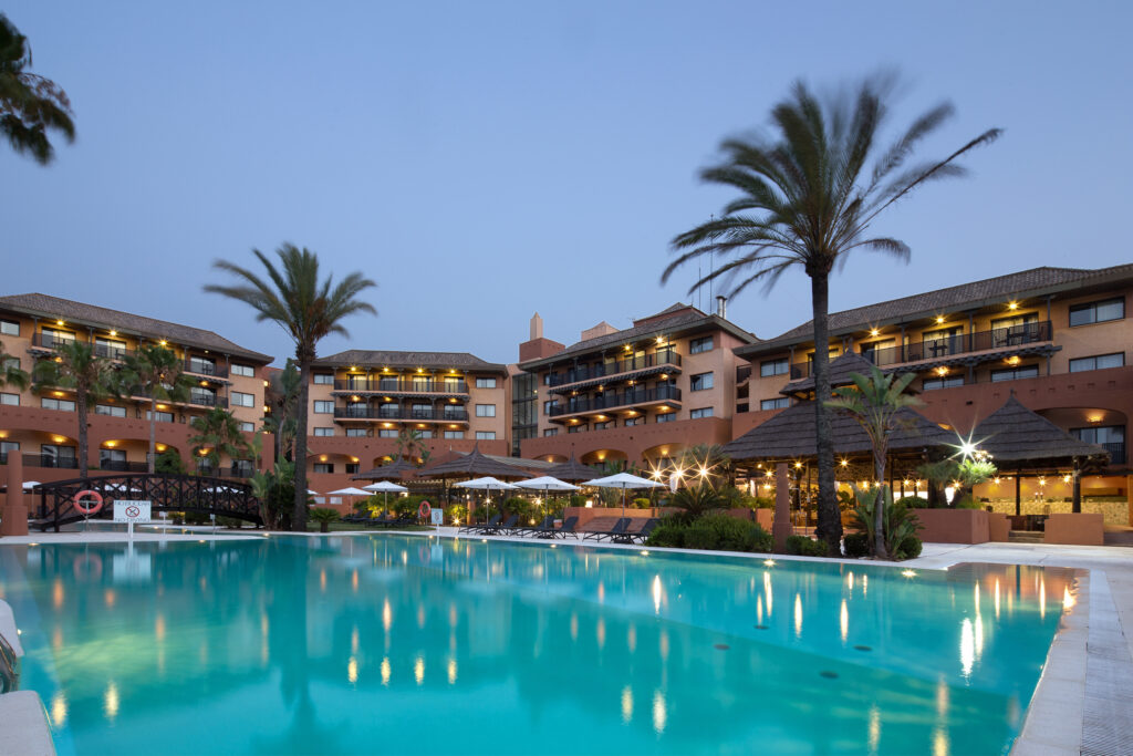 swimming pool with hotel behind