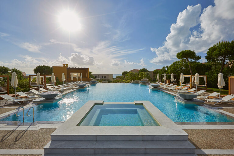 Swimming pool with sun loungers